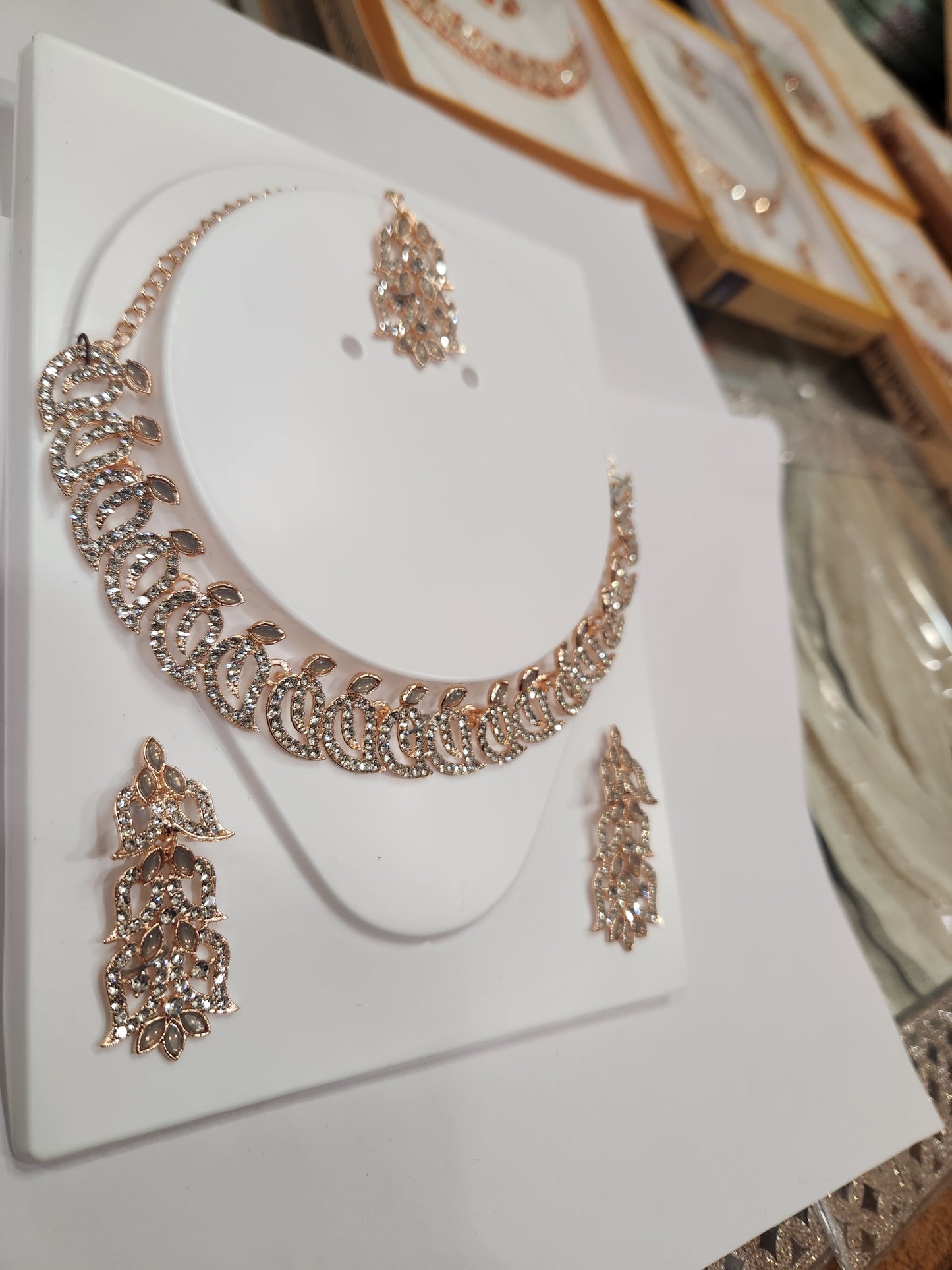 Classic white rhinestone necklace set with leaf-shaped earrings, perfect for any outfit and occasion.