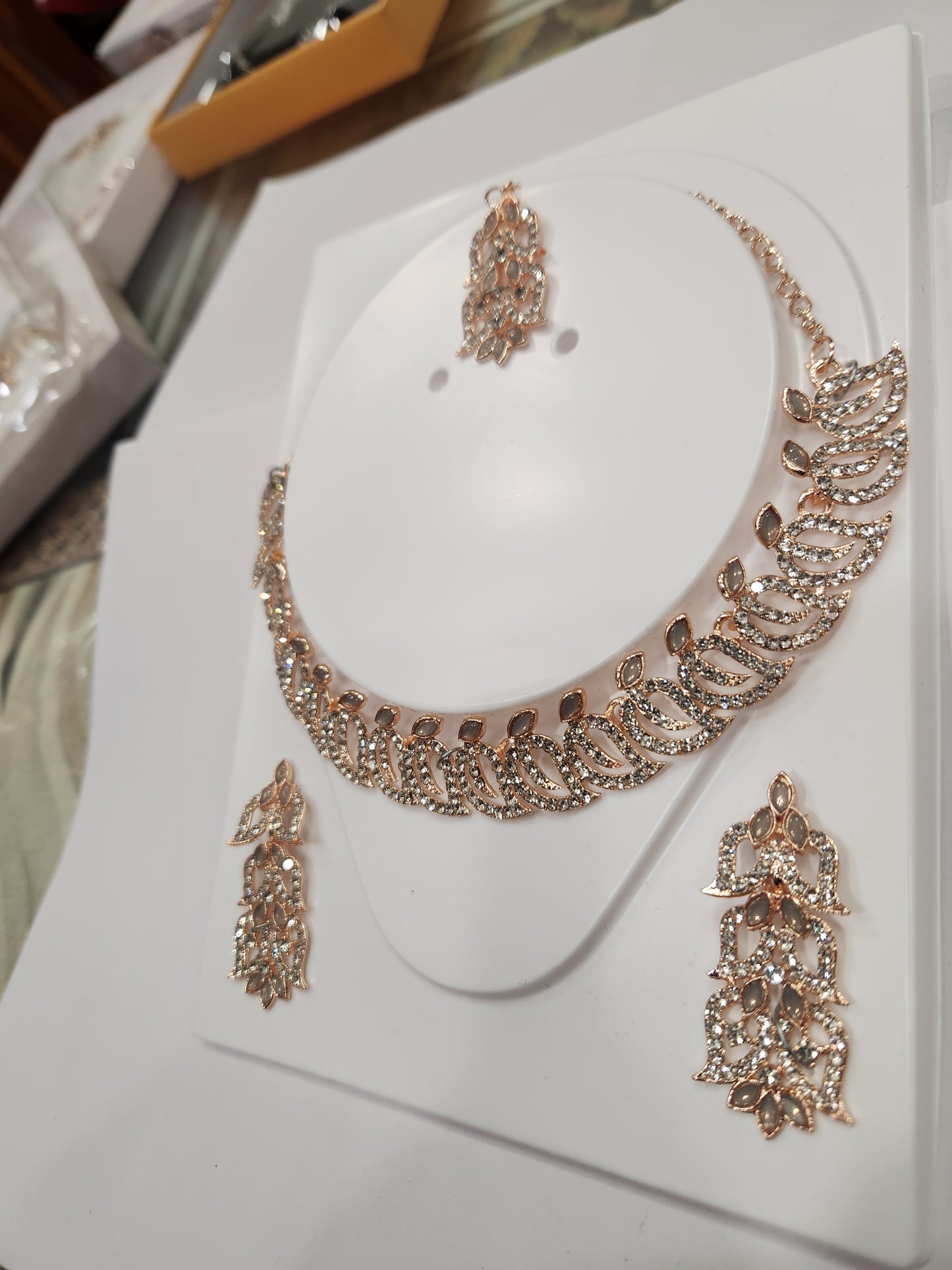 Classic white rhinestone necklace set with leaf-shaped earrings, perfect for any outfit and occasion.