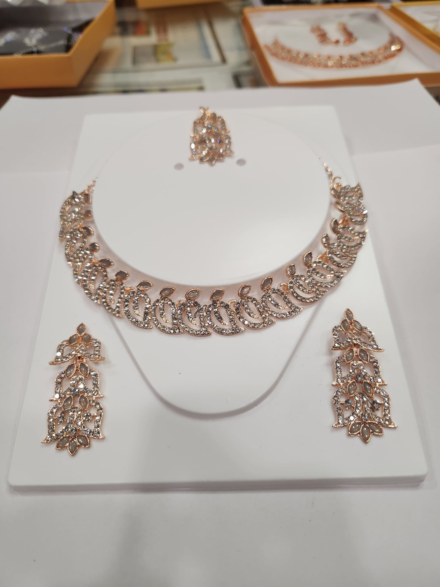 Classic white rhinestone necklace set with leaf-shaped earrings, perfect for any outfit and occasion.