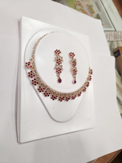 Elegant red and white rhinestone necklace set with flower-shaped drop earrings.