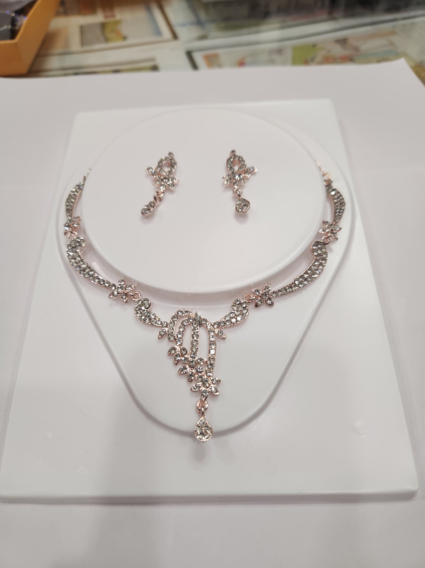 Unique asymmetric white rhinestone necklace set with statement earrings, perfect for any outfit and occasion.