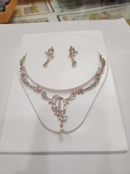 Unique asymmetric white rhinestone necklace set with statement earrings, perfect for any outfit and occasion.